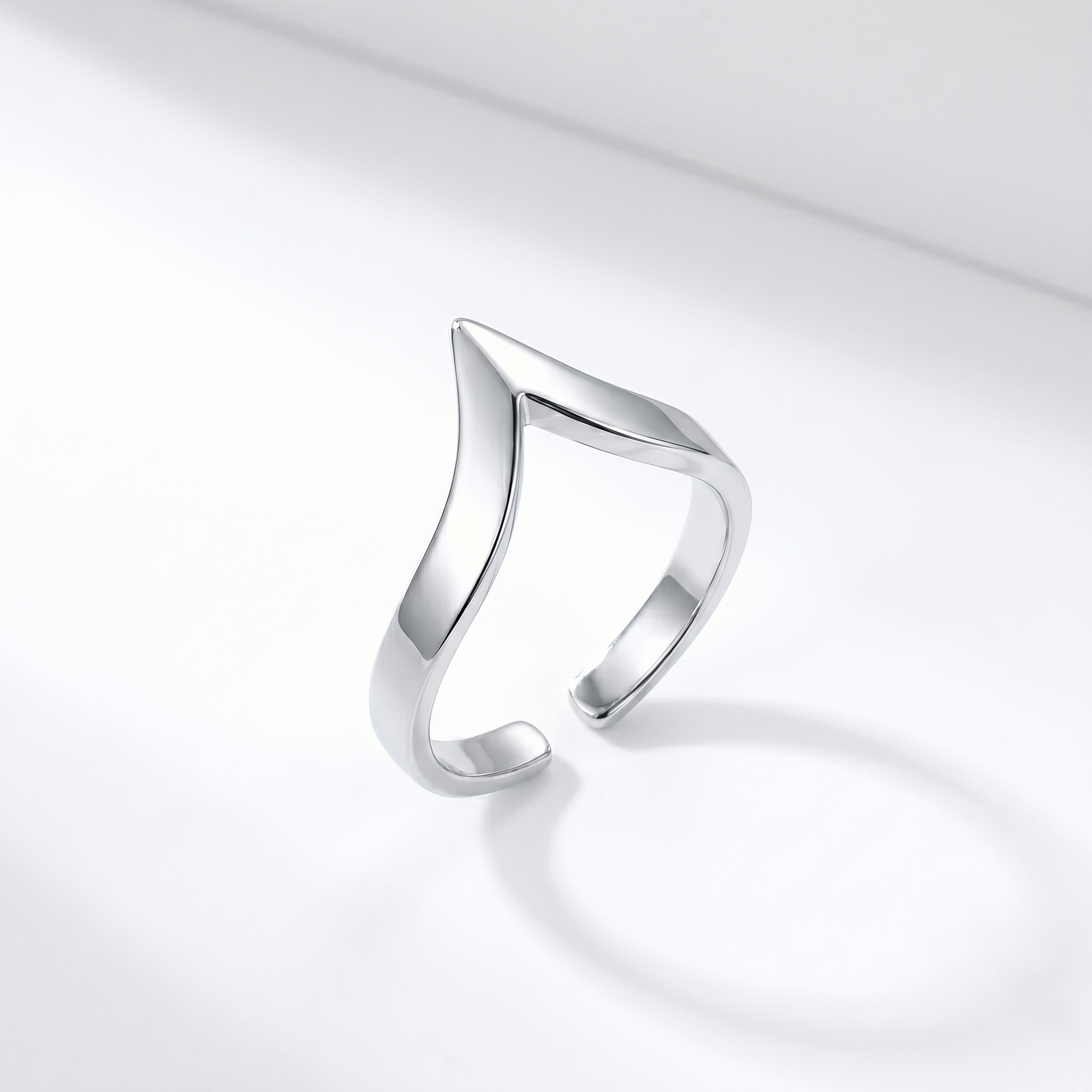 Silver wishbone V ring shown from the side, open V profile and shiny finish.