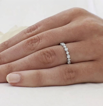 Silver CZ ring on finger with linked star bezels and round stones