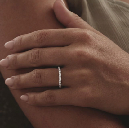 CZ stacking eternity band ring in silver tone worn on a hand, with sparkle stones