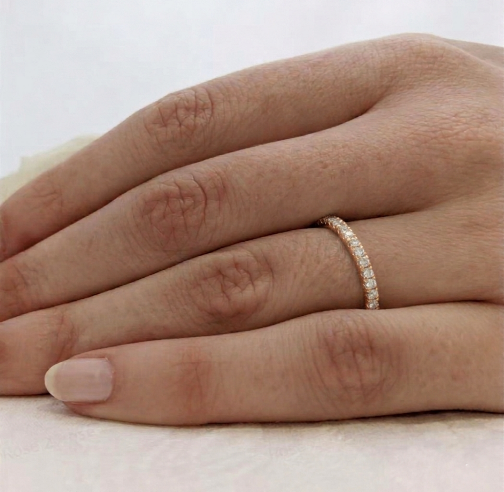 CZ stacking eternity band ring in gold tone on hand, set with round sparkle stones