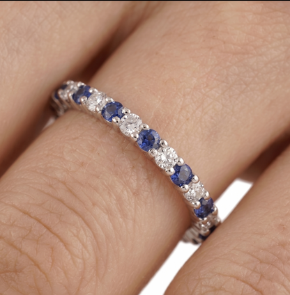 Sapphire Eternity Band on finger: blue round stones with clear accents in silver