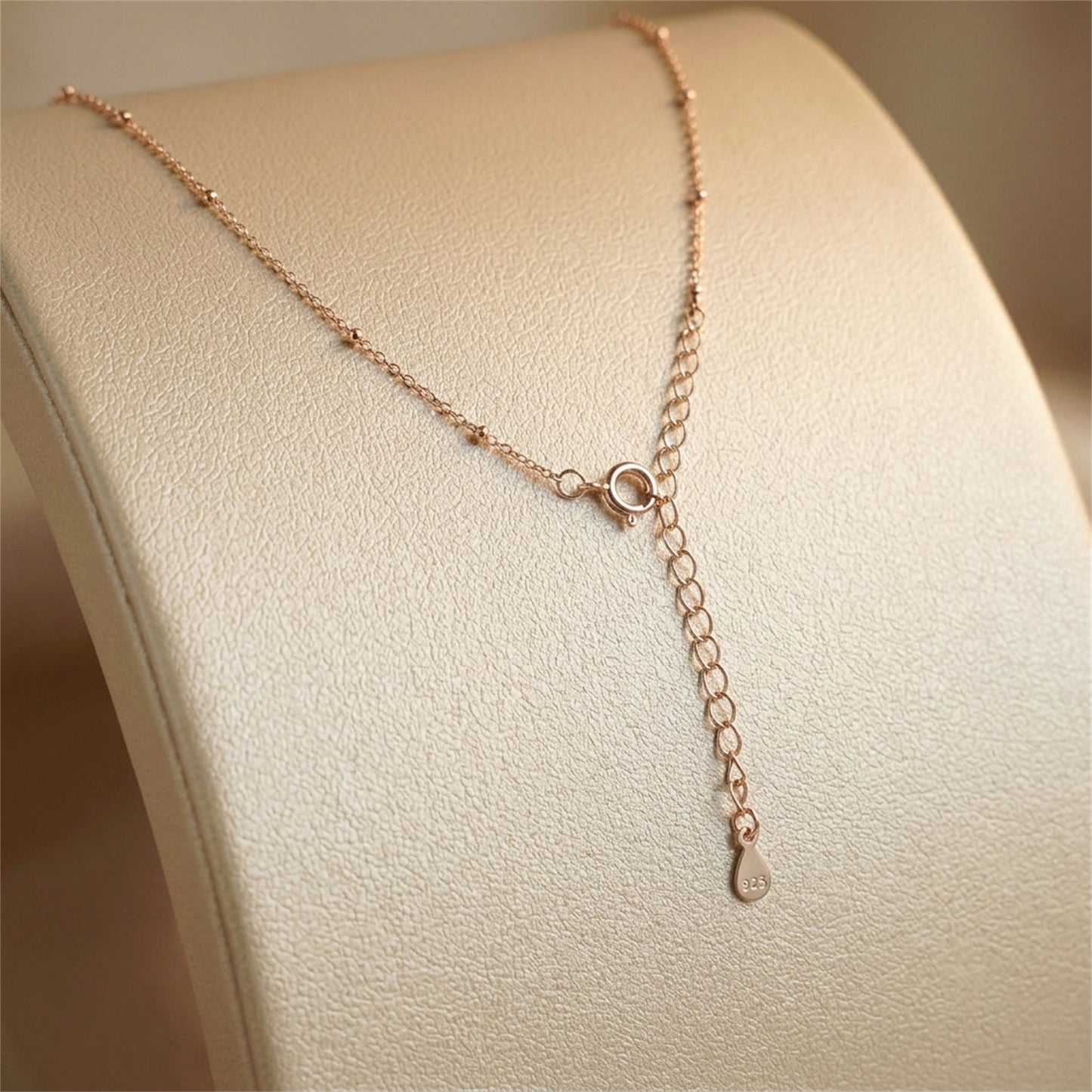 Rose gold flat beaded satellite chain necklace with ring clasp and drop charm