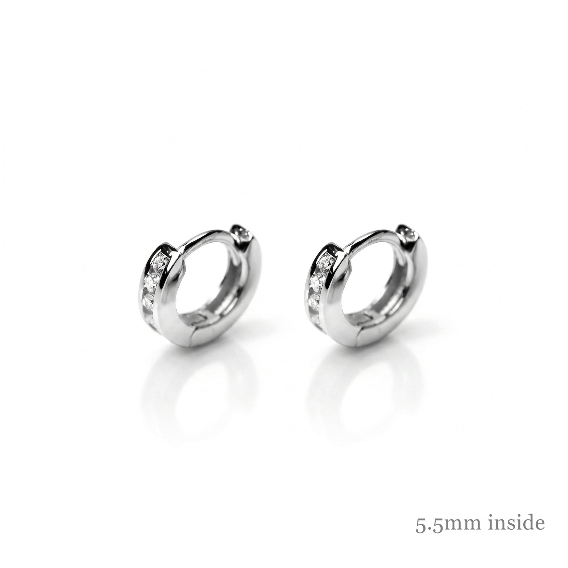 Channel Huggie Hoops in rhodium silver, rounded hoops with clear stone accents