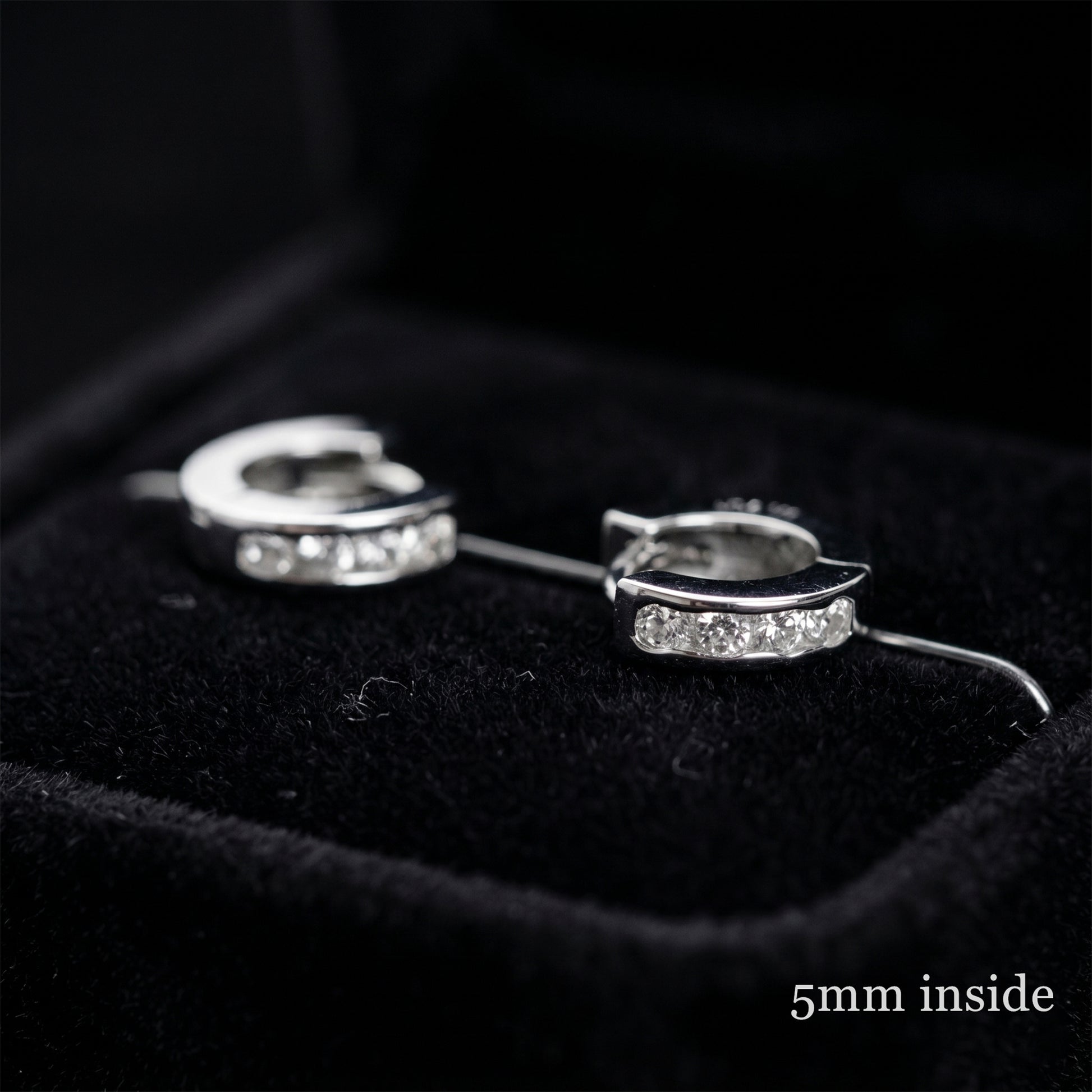 Rhodium Channel Huggie Hoops pair, curved bands with clear stones