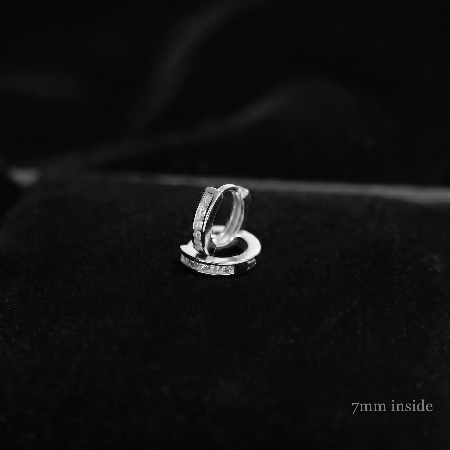 Channel Huggie Hoop earring, rhodium silver with clear stones; 7mm inside close-up