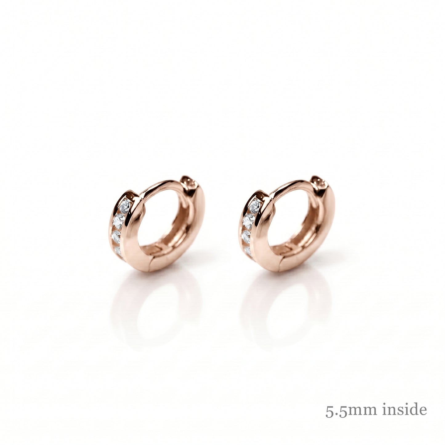 Rose Gold Channel Huggie Hoops with clear stones on the front bands