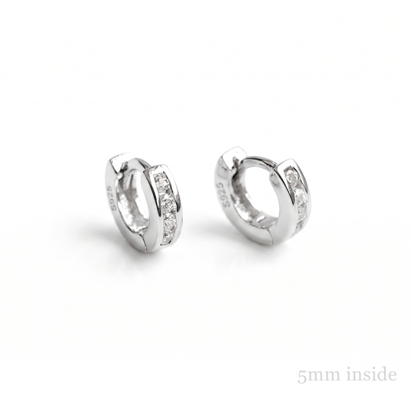 Channel Huggie Hoops in rhodium silver with clear stone detailing