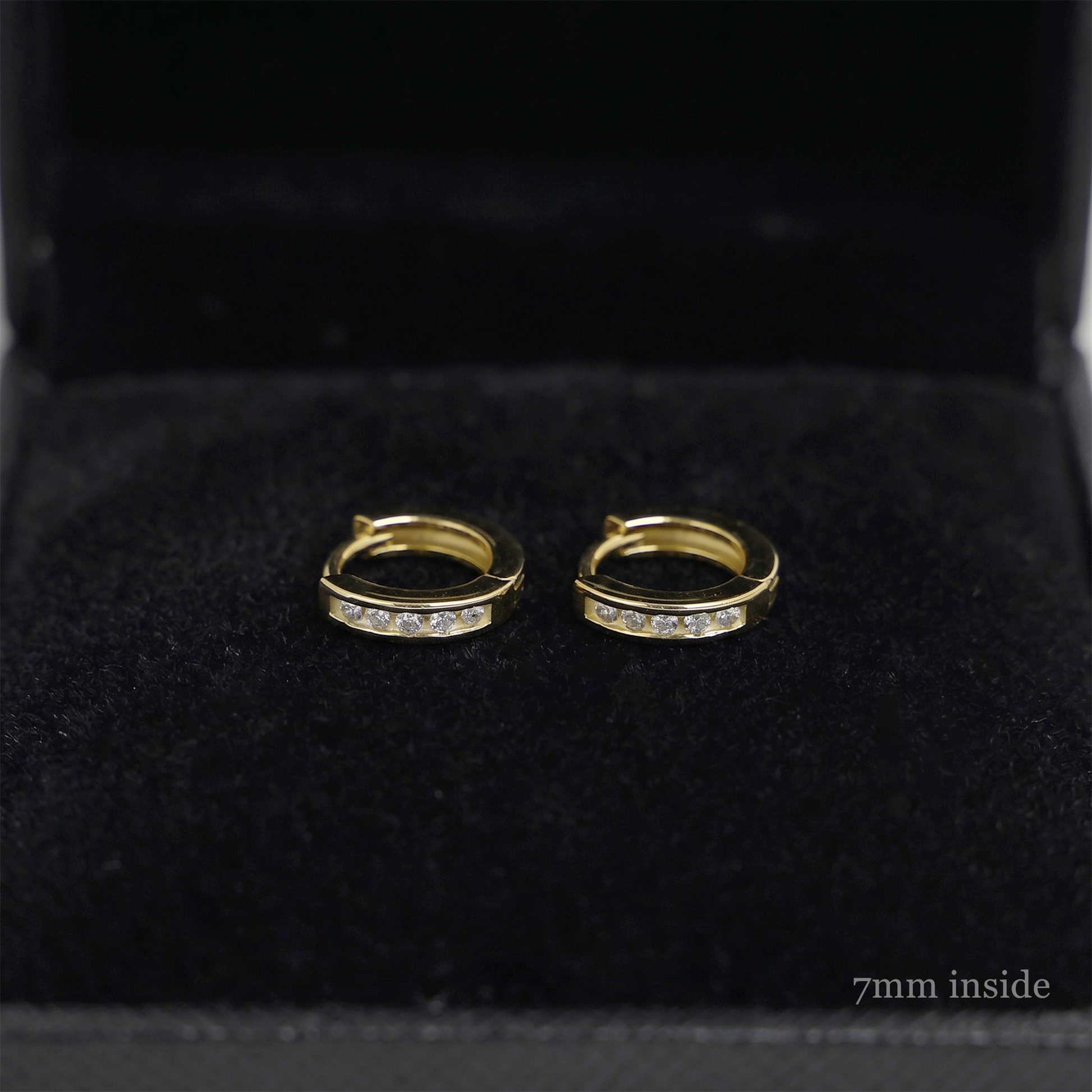 Channel Huggie Hoop earrings, gold tone with clear stone row; 7mm inside