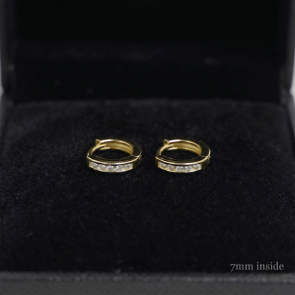 Channel Huggie Hoop earrings, gold tone with clear stone row; 7mm inside