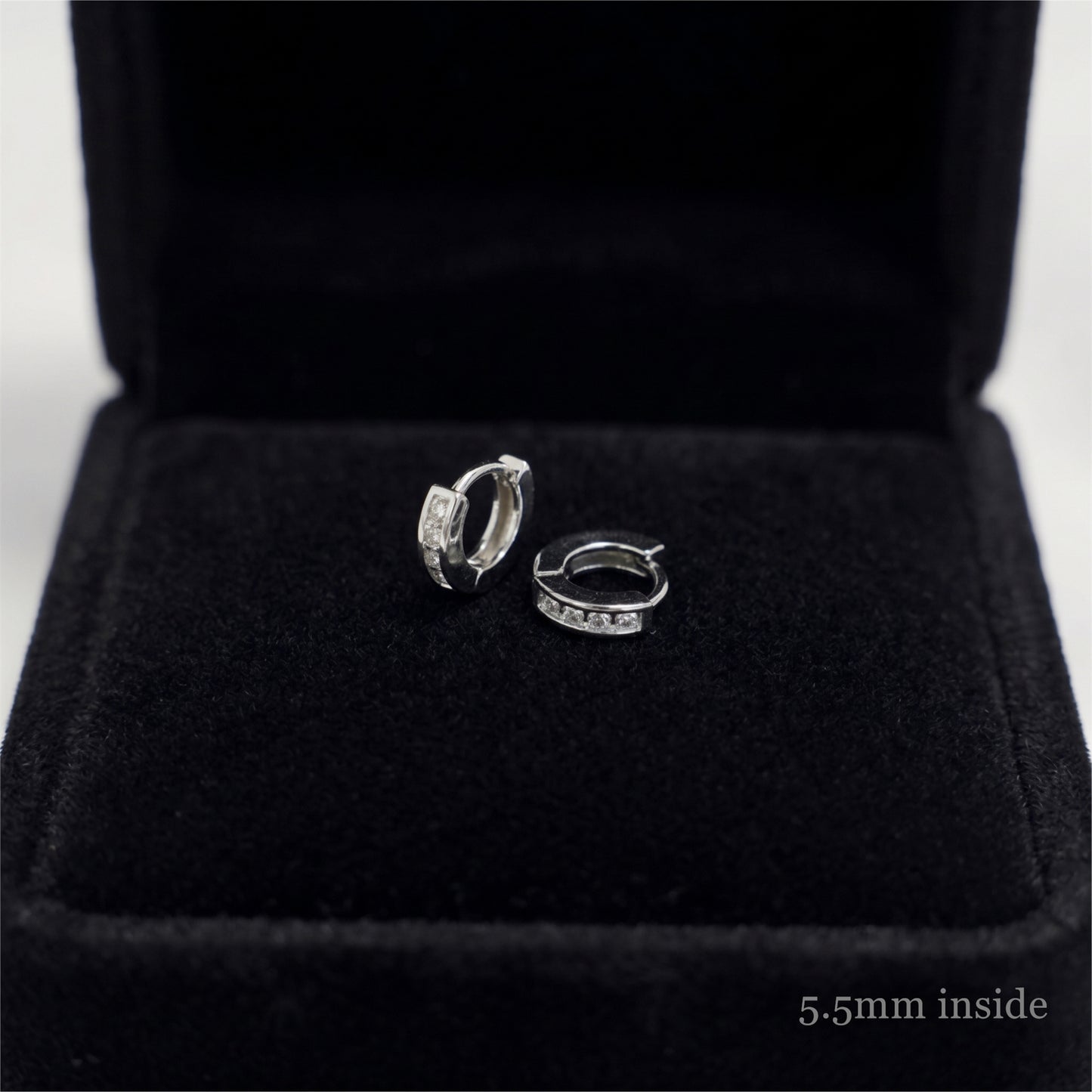 Rhodium Channel Huggie Hoops pair with open hinge and clear stones