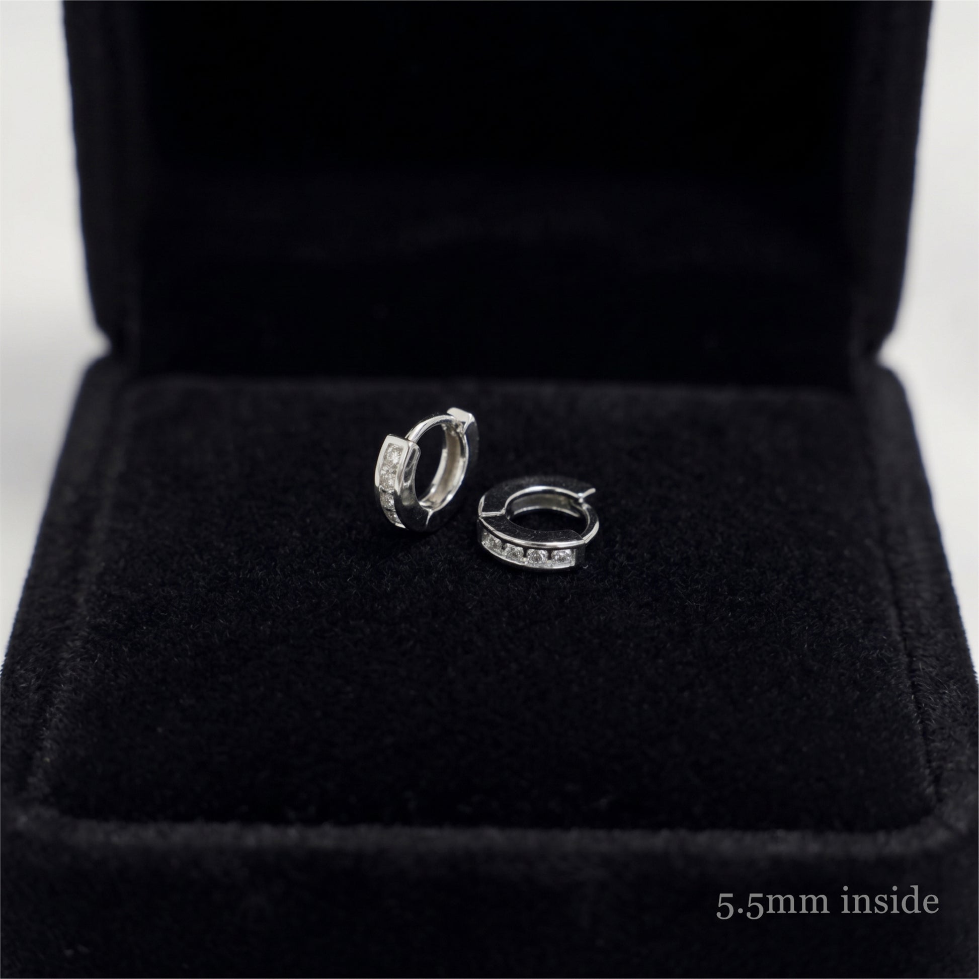 Rhodium Channel Huggie Hoops pair with open hinge and clear stones