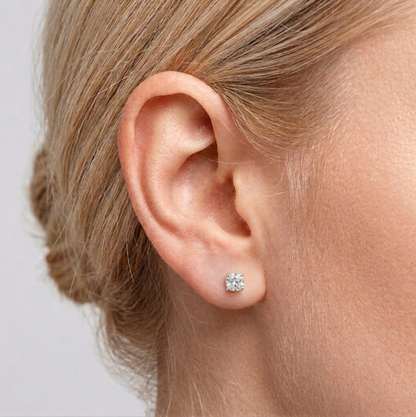 Round CZ solitaire stud earrings on ear with small clear round stone