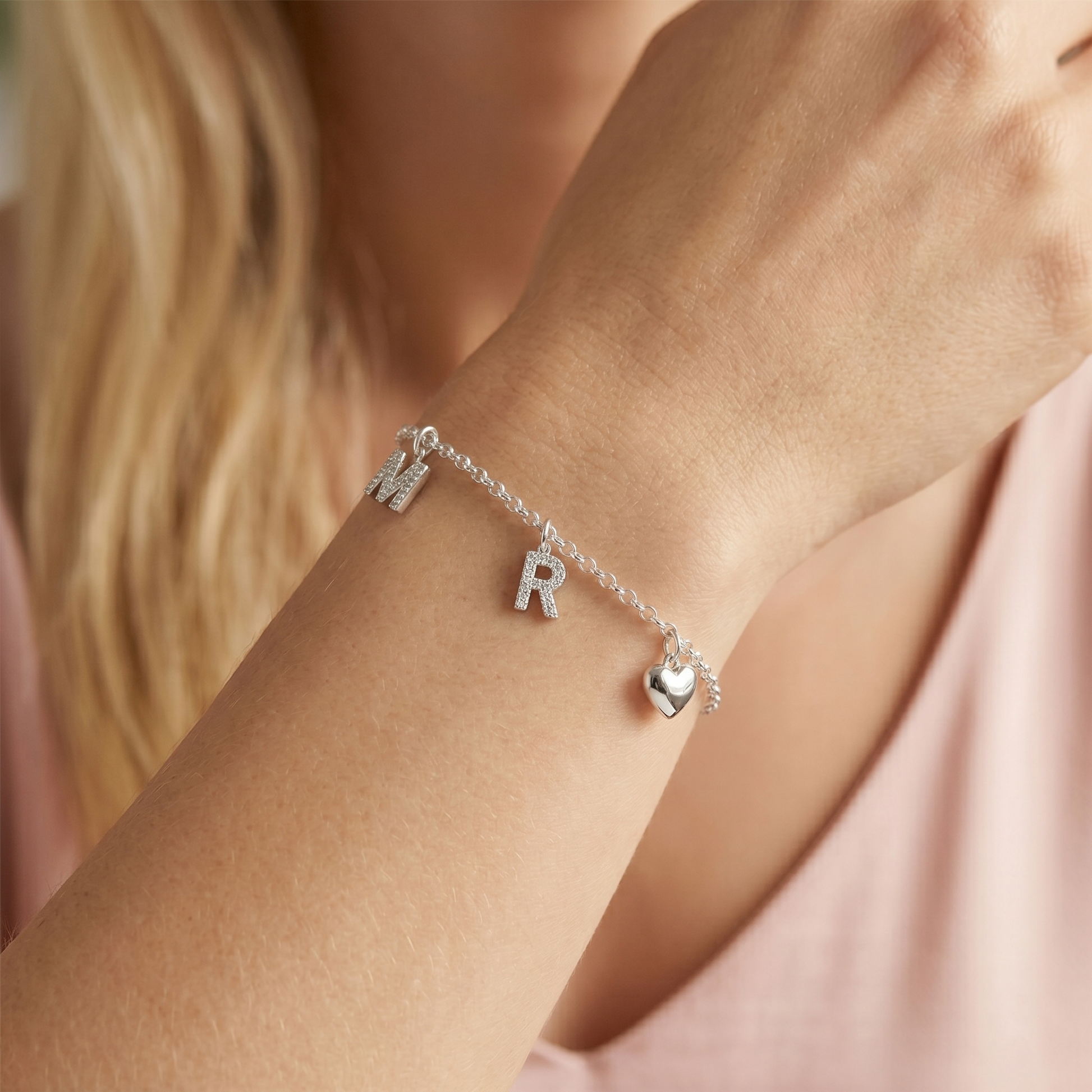 Charm bracelet with letter M and R mini alphabet charms and a heart charm