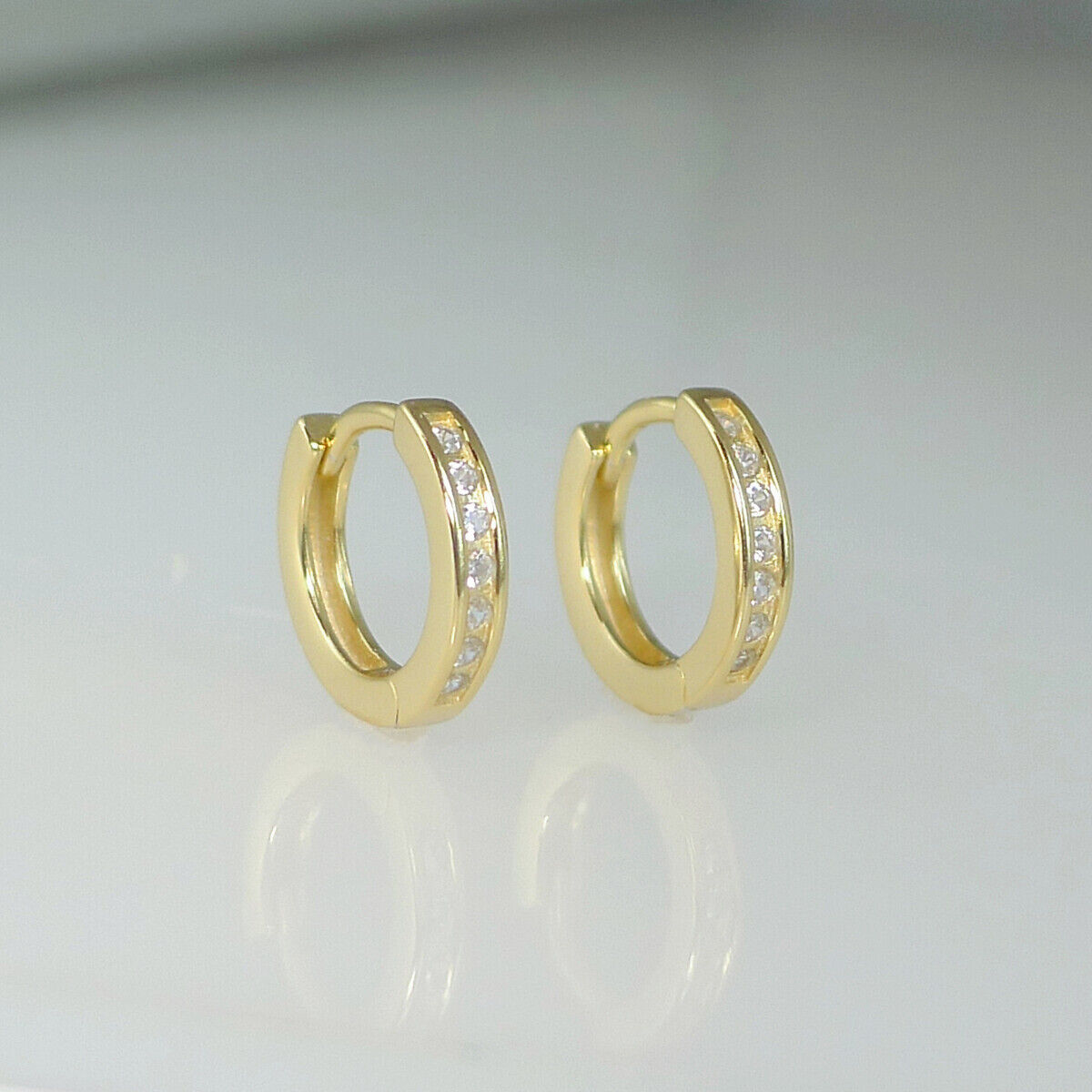 Sterling Silver 9mm Huggie Hoop Eternity Earrings with 18K Gold Plating and Channel-Set CZs - sugarkittenlondon